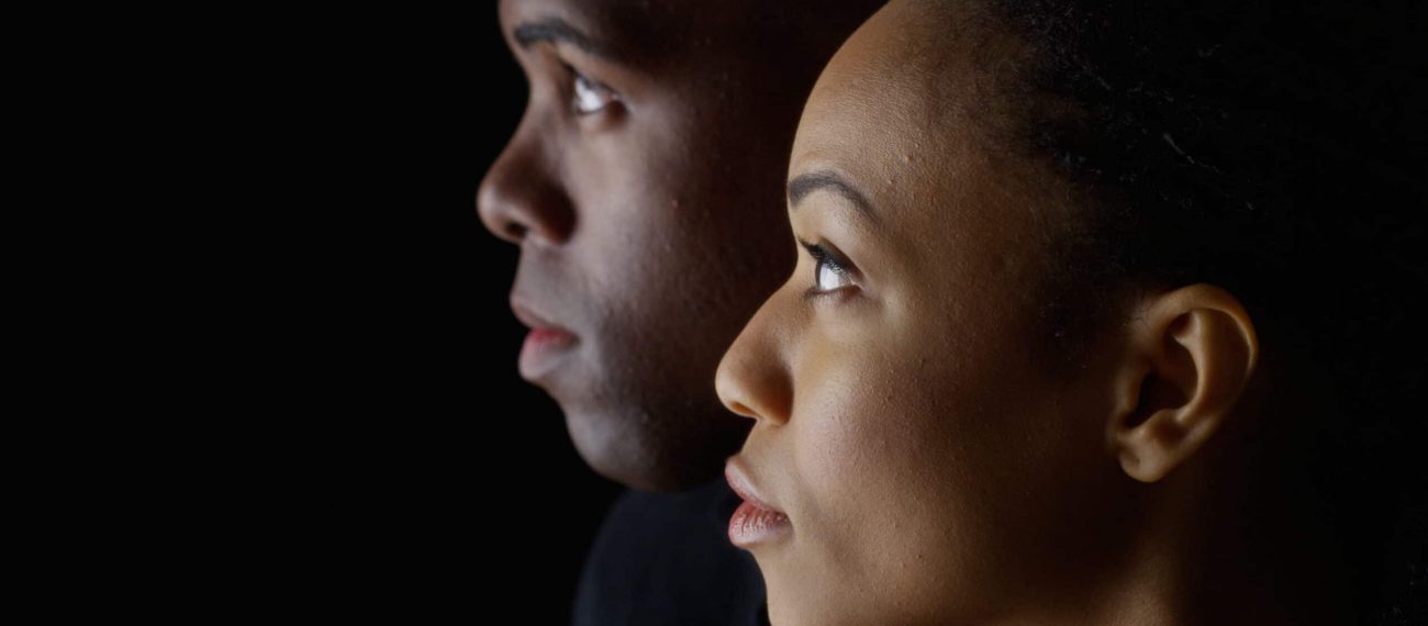 Dramatic profile of Black man and woman looking up